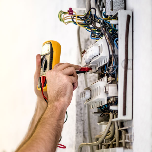 electrician inspecting circuit breaker